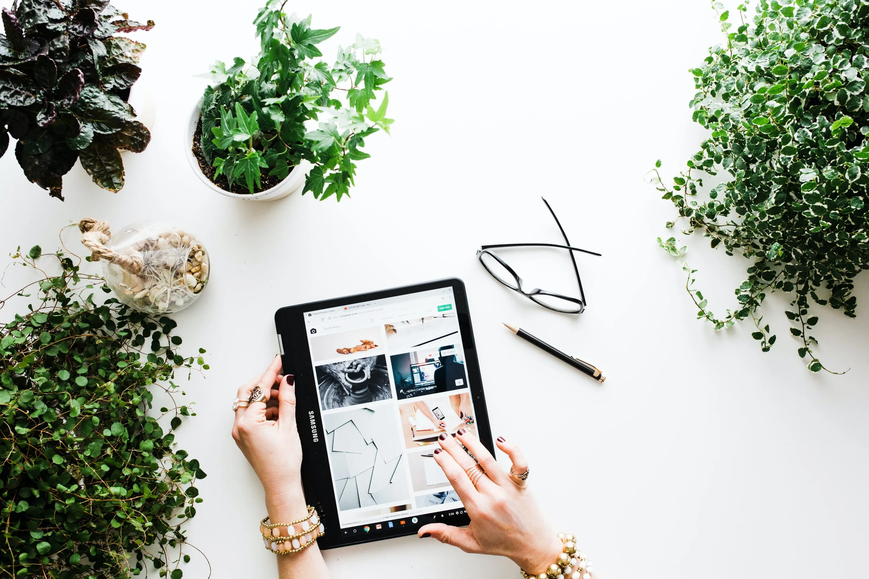 brooke-lark-W1B2LpQOBxA-unsplash woman taking notes while watching online video