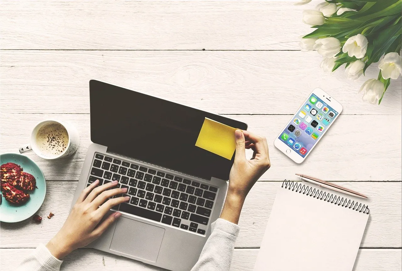 get-pinterest-manager-leads woman taking notes while watching online video